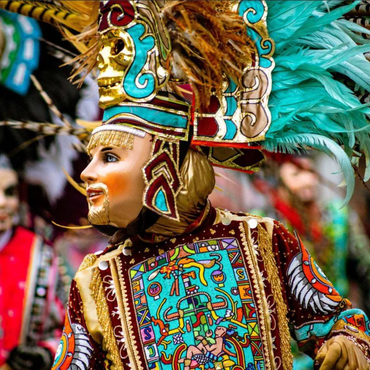 Dancer in a colorful traditional costume and mask