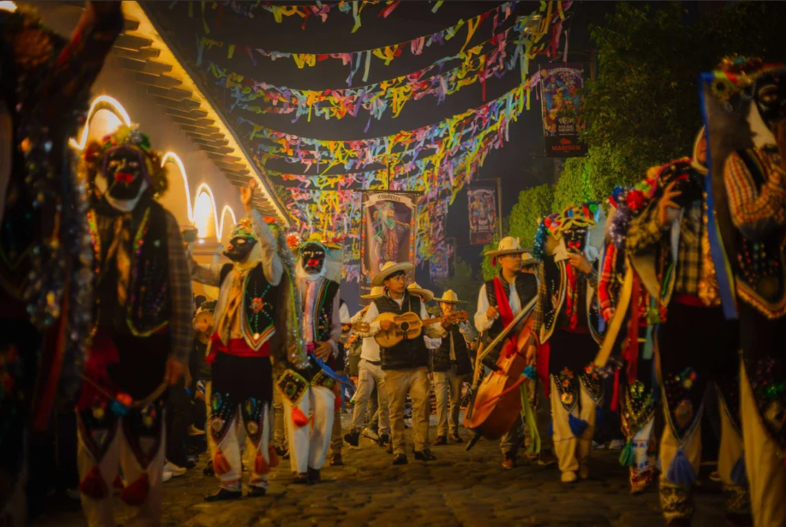 Dancers and musicians at a nighttime festival celebration